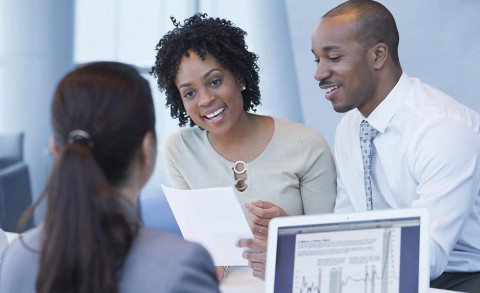 Couple speaking with banker