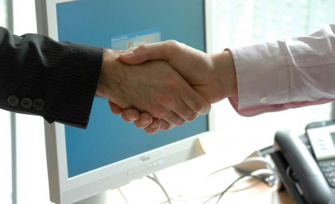Handshake over a desk