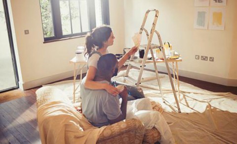 Couple painting a room