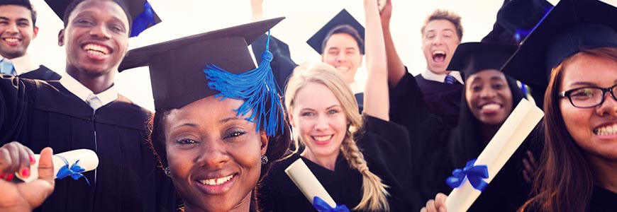 Graduates in cap and gown with diplomas