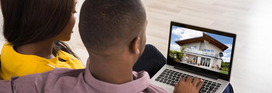 Couple looking at new home on a laptop