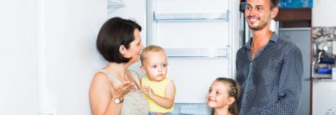 Family standing in kitchen