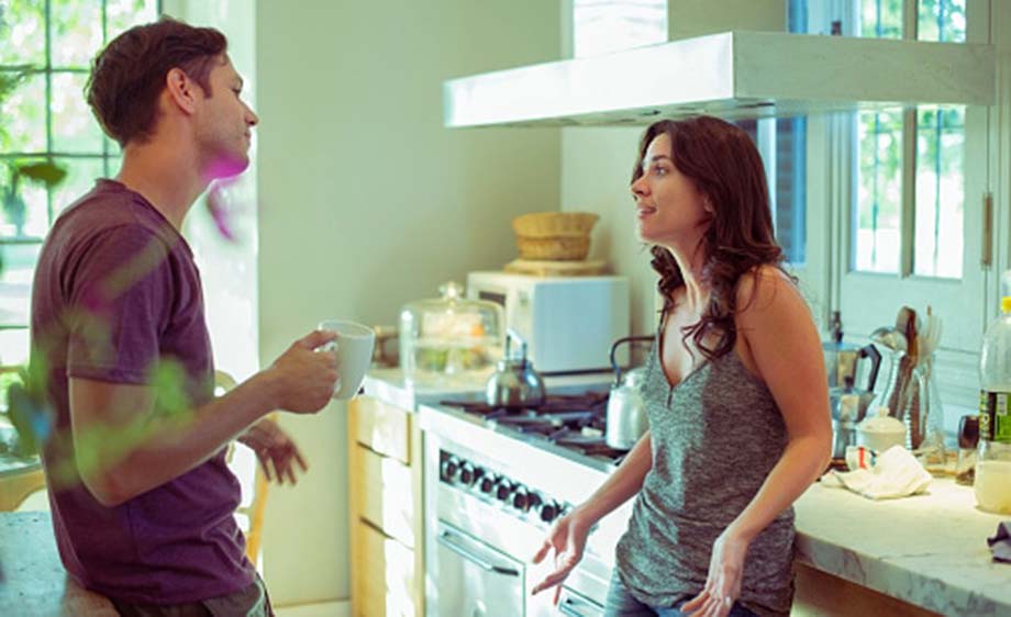 Couple talking in their kitchen