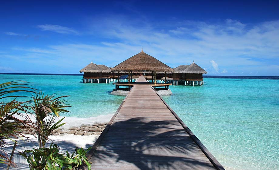 Dock leading to a bungalow on the ocean